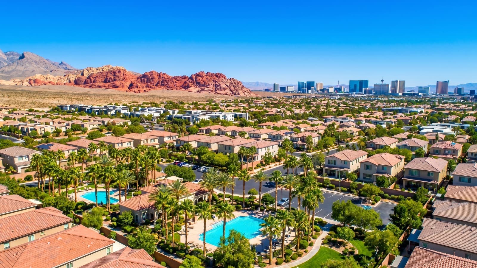 A waterfront home on Lake Las Vegas with a private dock and desert mountain panorama behind